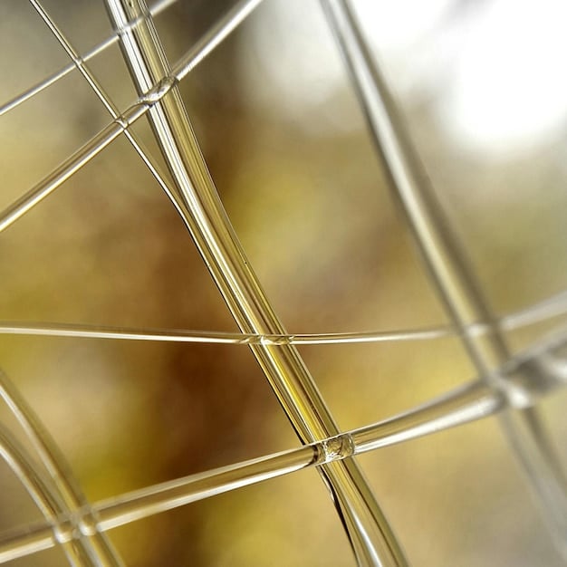 A detailed close-up of a solar panel farm, showing the individual panels reflecting the sunlight and the intricate grid system beneath them, emphasizing the technological advancements in solar energy production.