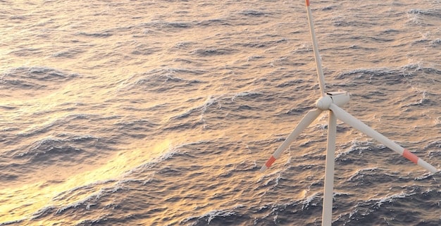 Aerial shot of a sprawling offshore wind farm in the North Sea, with numerous wind turbines standing tall against the backdrop of the ocean and a clear sky, highlighting the scale of offshore wind energy production.