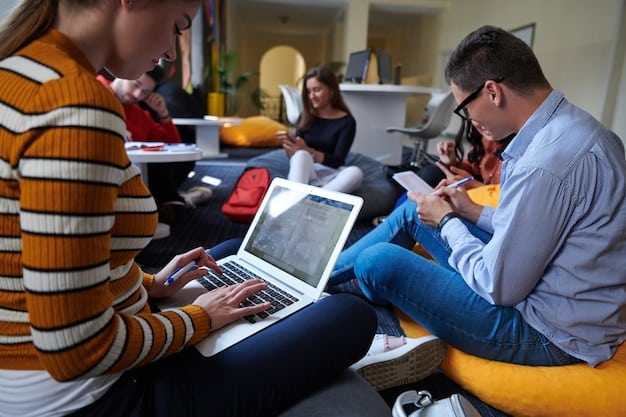 A group of students collaborating on a project using laptops in a modern, open-plan learning space, emphasizing teamwork and digital skills.