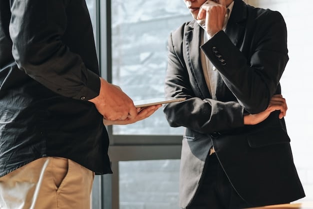 Man shaking hands while signing a contract.