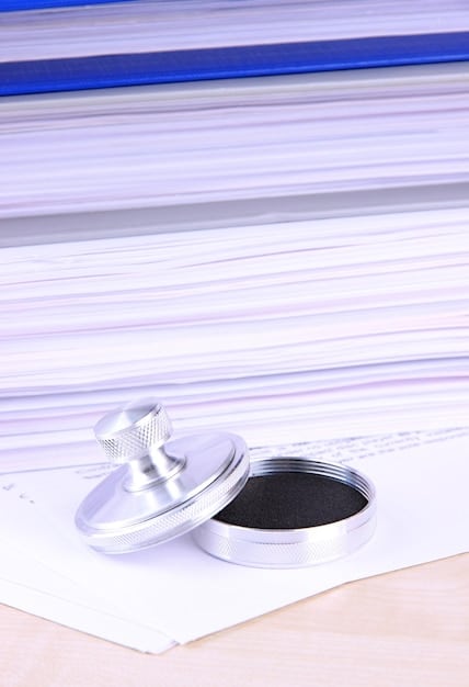 A close-up shot of customs documents with stamps, highlighting the increased bureaucracy and paperwork involved in trading between Germany and the UK post-Brexit. The background is blurred, showing a stack of files.