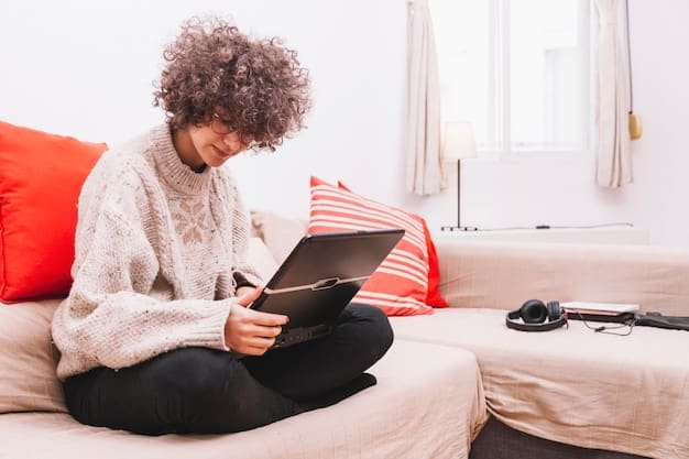 A person sitting on a couch, comfortably browsing a tablet, showcasing the convenience and comfort of online shopping from home.